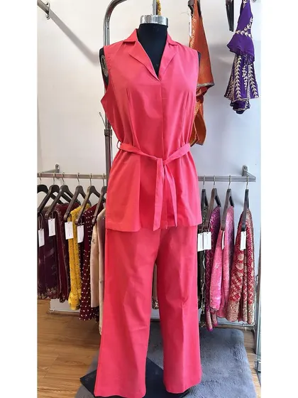 A beautiful example of our cotton linen sets, shown here in a vibrant coral pink. This sleeveless top and wide-leg trouser combination is breathable, comfortable, and effortlessly chic for warm weather.