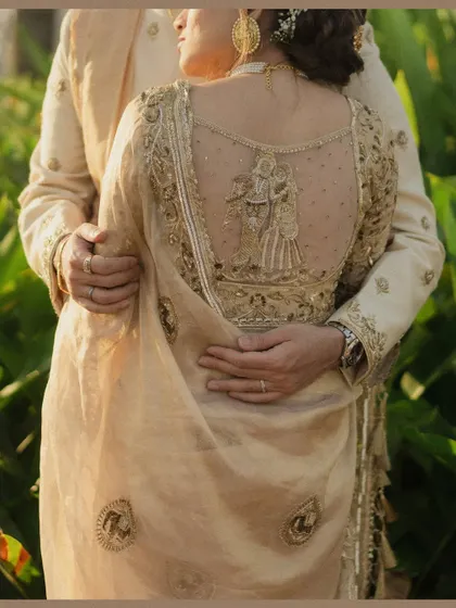 We believe beauty is in the details, like the intricate embroidery on a bride's blouse telling a story of its own. This close-up highlights the craftsmanship and personal touches that make a wedding day so special.