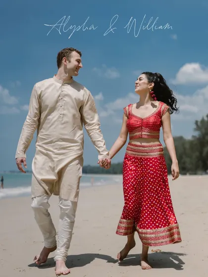 A beautiful, candid moment of Alysha and William walking hand-in-hand on the beach in Thailand, their love story set against a stunning international backdrop.