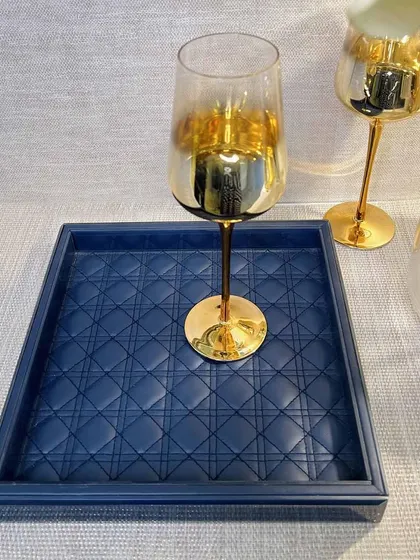 For a touch of color, our Amadeus tray in deep blue offers a sophisticated alternative. The luxurious leather interior and sleek glass frame make it a perfect tray for serving drinks.
