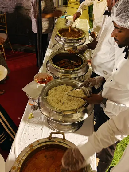 Our uniformed staff serving guests at a buffet line. We focus on providing a smooth, hygienic, and professional service so you can focus on your event.