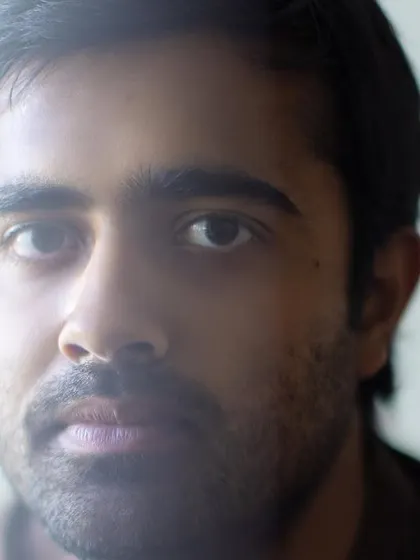 A close-up portrait of our puppeteer and actor. His focus and skill are essential to bringing our puppet characters to life with nuance and personality.