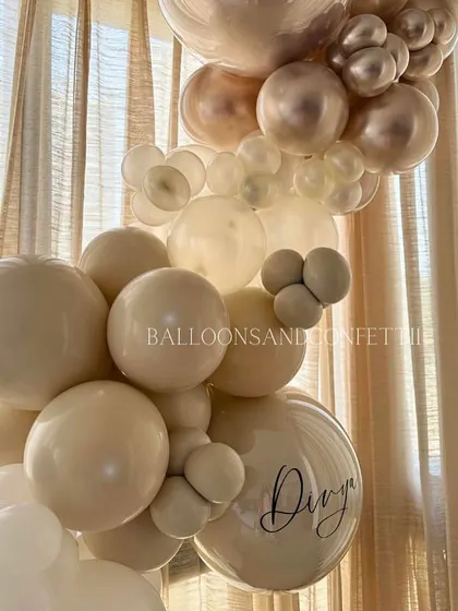 A detailed shot of the neutral-toned balloon garland. The mix of different sizes and shades creates an elegant, organic look that complements any modern home interior.