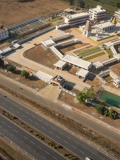 This aerial view clearly shows the entire 6.5-acre site layout, including parking, the temple tank, and the phased development of the complex.