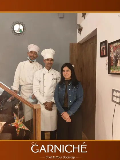 Our team is ready to serve. Two of our chefs posing with a client in her home, ready to create a memorable dining experience for her and her guests.
