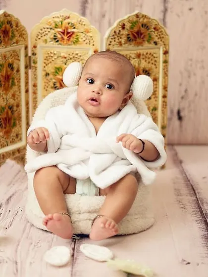 This baby's wide-eyed expression is priceless. It shows that themed shoots can capture a range of emotions, not just sleepy poses.