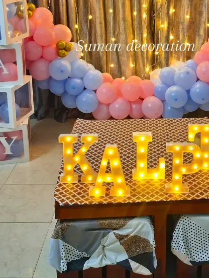 A close-up of the 'BABY' blocks and marquee letters used in the welcome home decoration.
