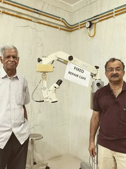 Here is the fully repaired and functional surgical microscope, with our proud mentors standing by. This project shows the incredible impact that community repair skills can have.
