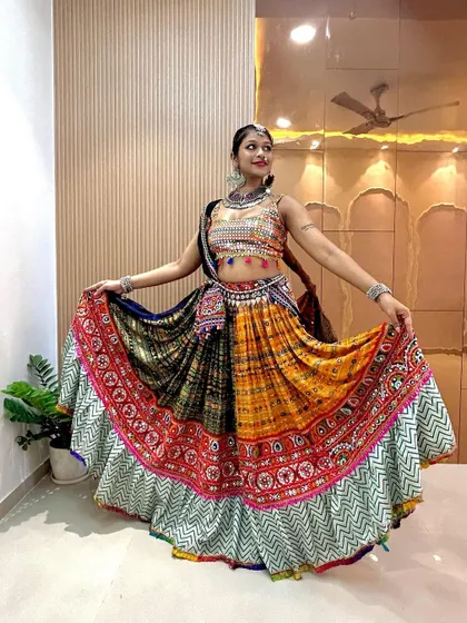 Standing view of the multi-panel chaniya choli, showcasing the detailed embroidery and patchwork on the skirt and the matching mirror-work blouse.