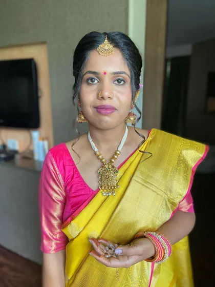 A full portrait of the bride, looking radiant and confident in her complete South Indian bridal look.