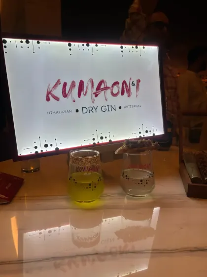 The branding for Kumaoni & I Himalayan Dry Gin, beautifully lit at the bar during the launch event. My hosting ensures that every detail of the brand's identity is highlighted throughout the evening.