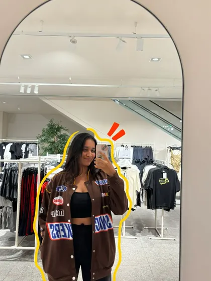 A mirror selfie showing off a cool new jacket, with a yellow outline to make it pop.