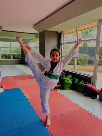 A standing split, showcasing excellent balance and hamstring flexibility. This translates directly to higher, faster kicks.