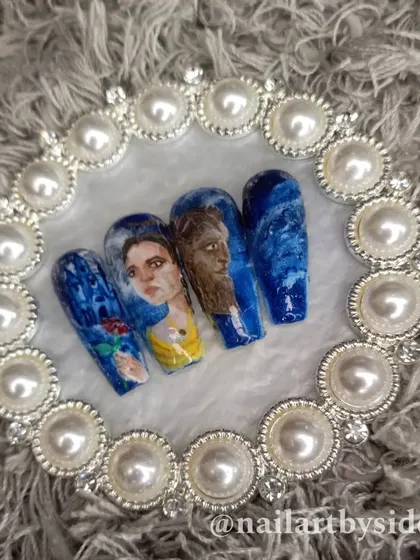 Another angle of the "Beauty and the Beast" nail set, highlighting the portrait of the Beast and the enchanted rose.