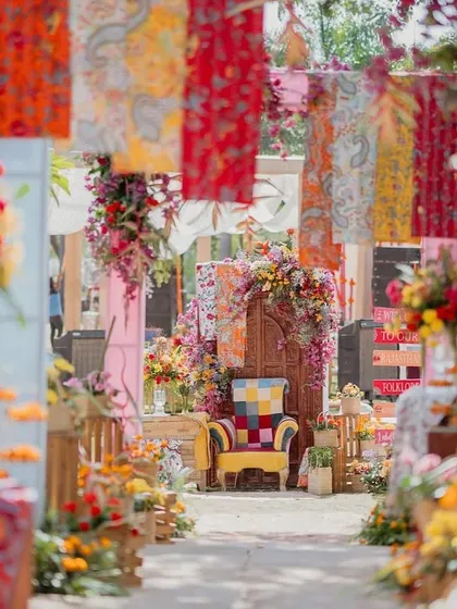 A view down the aisle of our 'Rajasthani Folklore' Mehendi. The hanging patchwork fabrics and floral-draped arch created a stunning entrance and a perfect photo opportunity.