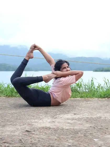 A reminder to let go and move forward. Practicing Poorna Dhanurasana (Full Bow Pose) by the water.