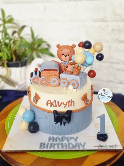 All aboard the birthday express for Advyth's first birthday. This cake features a cute teddy bear conductor on a fondant train, perfect for a little boy's big day.