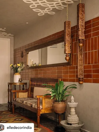 The private foyer of the 'Brihati' home welcomes you with the warmth of brick, oxide walls, and vintage-inspired furniture. I took the traditional 'kolam' and gave it an unconventional twist by mounting a larger-than-life version on the ceiling, creating an immediate sense of arrival.