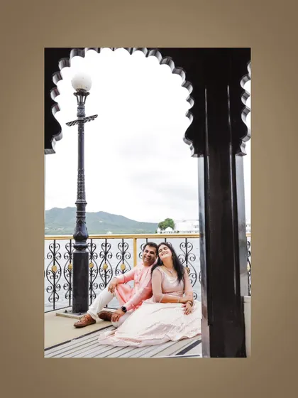 A relaxed post-wedding portrait of a couple enjoying the lakeside view in Udaipur.