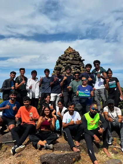 A proud group of trekkers at the Kumara Parvatha summit. This 21 km circuit trek is a serious challenge, and reaching the top is a moment of pure triumph.