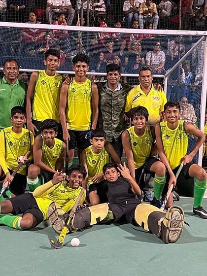 The team celebrating their win in front of a packed crowd.