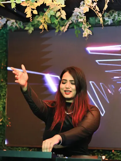 A shot from a live performance, interacting with the crowd against a backdrop of custom LED visuals.