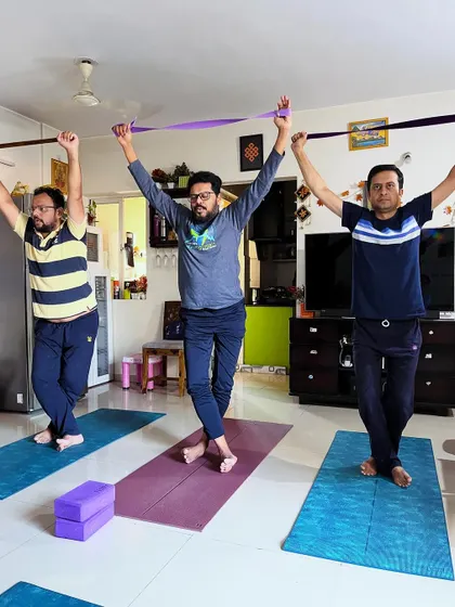A group of male clients use resistance bands to work on shoulder mobility and stability. This is a great warm-up or cool-down exercise to improve posture and prevent injury.