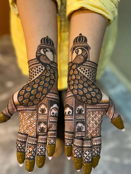 A regal Karwa Chauth design featuring majestic peacocks with crowns. The lower part of the palms includes traditional motifs like elephants and lotuses, creating a rich, royal look.