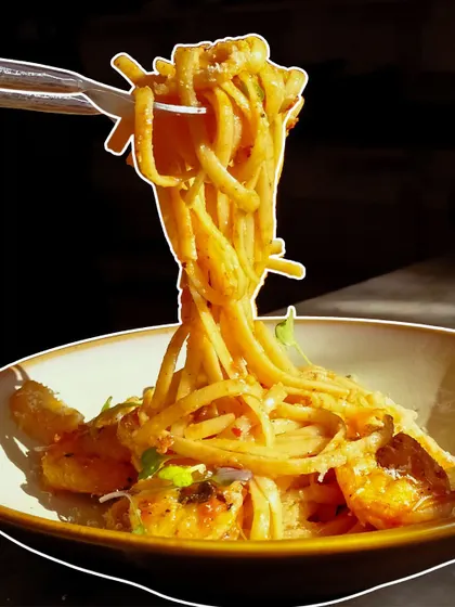 That perfect pasta twirl. This shot captures a forkful of our creamy and delicious pasta, proving that some love stories start with sizzling hot food.