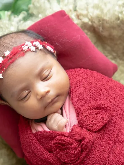 Words cannot express the joy of a new life. This close-up shows the beautiful face of a newborn, with a tiny star-adorned headband.