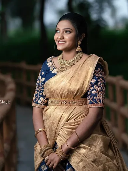 A smiling model wearing our rental half-saree and matching jewellery. This shows how you can get a fully coordinated look effortlessly.