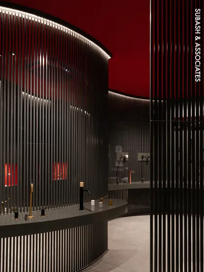 A view into the FIMA Store, where we used vertical steel partitions and a bold red ceiling to create an immersive, gallery-like experience. This design guides customers through a curated space, highlighting products with dramatic lighting and a strong color palette.