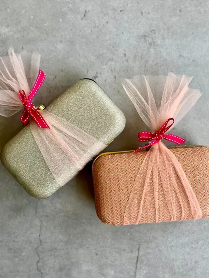 A pair of elegant clutches, beautifully wrapped in tulle, ready to be gifted to bridesmaids.