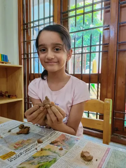 This older camper is happy with the small clay figure she is sculpting. We tailor activities to be engaging for all age groups, from 4 to 14.
