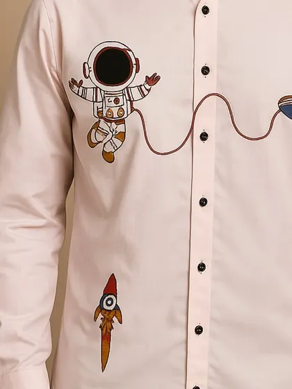 Another close-up of the embroidery details on this custom pink shirt. The design is perfect for someone looking to express their individuality.