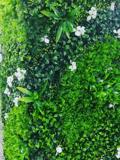 Here is a vertical garden installed on a pillar in an office space. Covering structural elements like this is a smart way to integrate greenery into an open-plan office without taking up floor space.