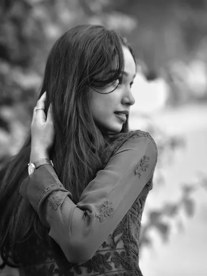 A beautiful black and white portrait with a soft, dreamy feel. The focus on her profile and the gentle light create a timeless and artistic image.