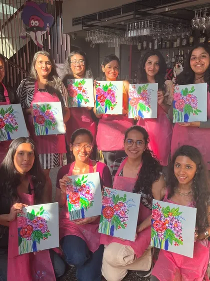 A group of ladies proudly showing their floral bouquet paintings. The sense of accomplishment after finishing a painting is wonderful.