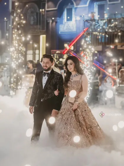 The couple makes a grand entrance, walking through a cloud of smoke at their reception.