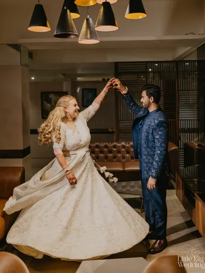 A joyful, candid moment of the couple dancing together. We capture the movement and happiness that defines a great party.