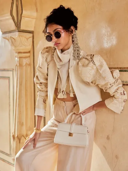 Power-packed and stylish. This Indo-Western set with a structured jacket and puffed sleeves is a high-fashion statement for the modern woman.