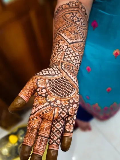 A close-up of a palm filled with intricate details, including checkerboard patterns and floral elements.
