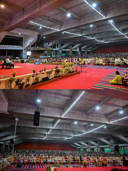 A wide shot of the Dhyan Mandir packed with thousands of participants for the Patanjali Yoga Sutras. The sheer number of people gathered to listen to ancient wisdom shows the deep collective thirst for inner peace.