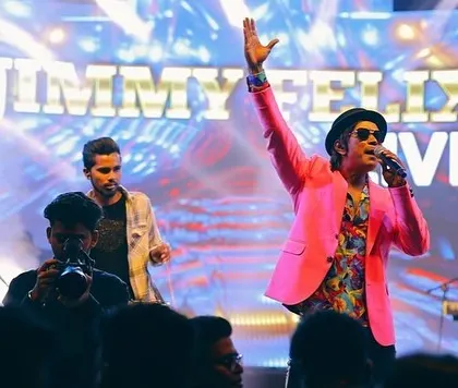 In my element with the band, bringing the energy for a corporate awards night. The pink jacket was just for that extra flair.