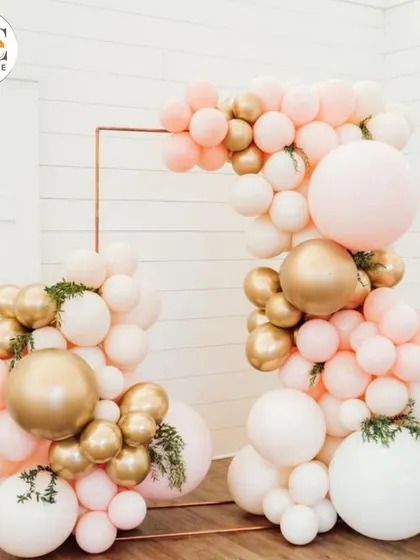 A simple yet elegant balloon arch in pastel pink, white, and gold. This type of decor is versatile and can be used to frame a dessert table, entrance, or photo area.
