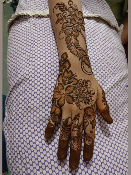 A lovely floral design that extends up the arm. The pattern is a mix of different flowers and leaves, creating a beautiful bouquet on the skin.