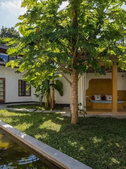 The private garden of the Garden Suite at Jalakara, complete with a lily pond and a sheltered outdoor daybed.