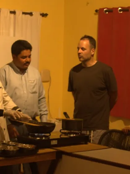 Another view of our chef interacting with guests during a cooking class, explaining the art and science behind Ayurvedic recipes.