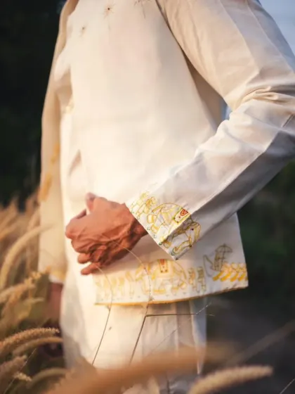 A detail shot of the custom embroidery on the cuff of Vishak's jacket, featuring whimsical elephant motifs.