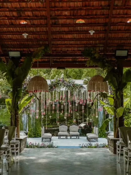 A view from the back of the ceremony space, showing the rows of beautifully decorated chairs leading towards the mandap.